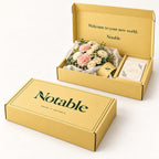 Soft Landing bouquet in its butter Notable box, closed box and open box